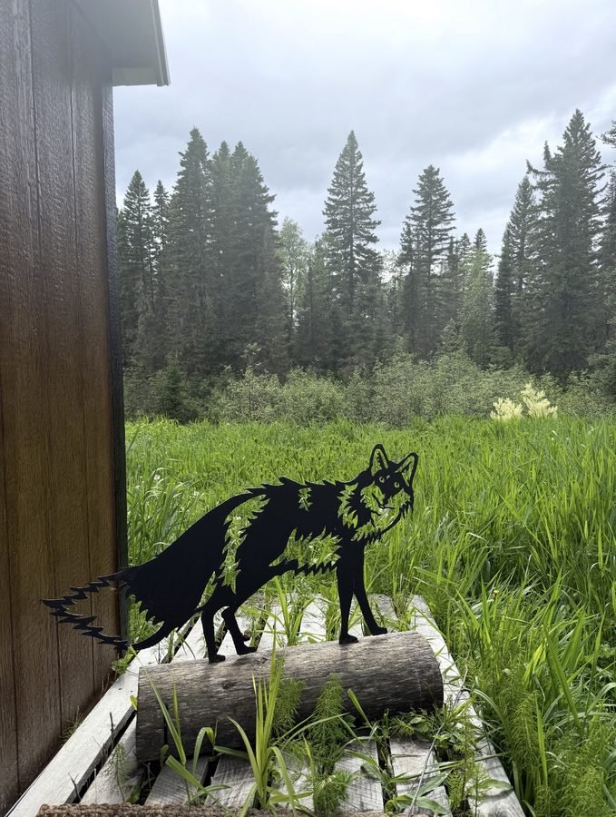A fox statue on the office deck overlooking the meadow